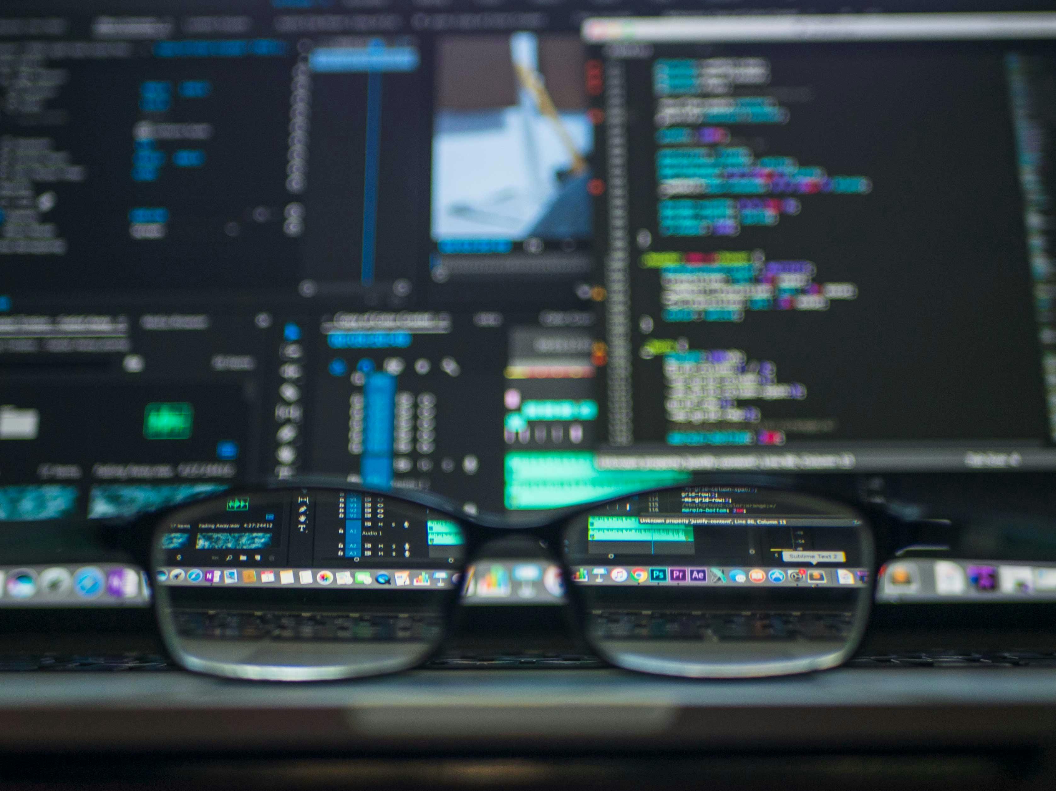 A person coding on a laptop